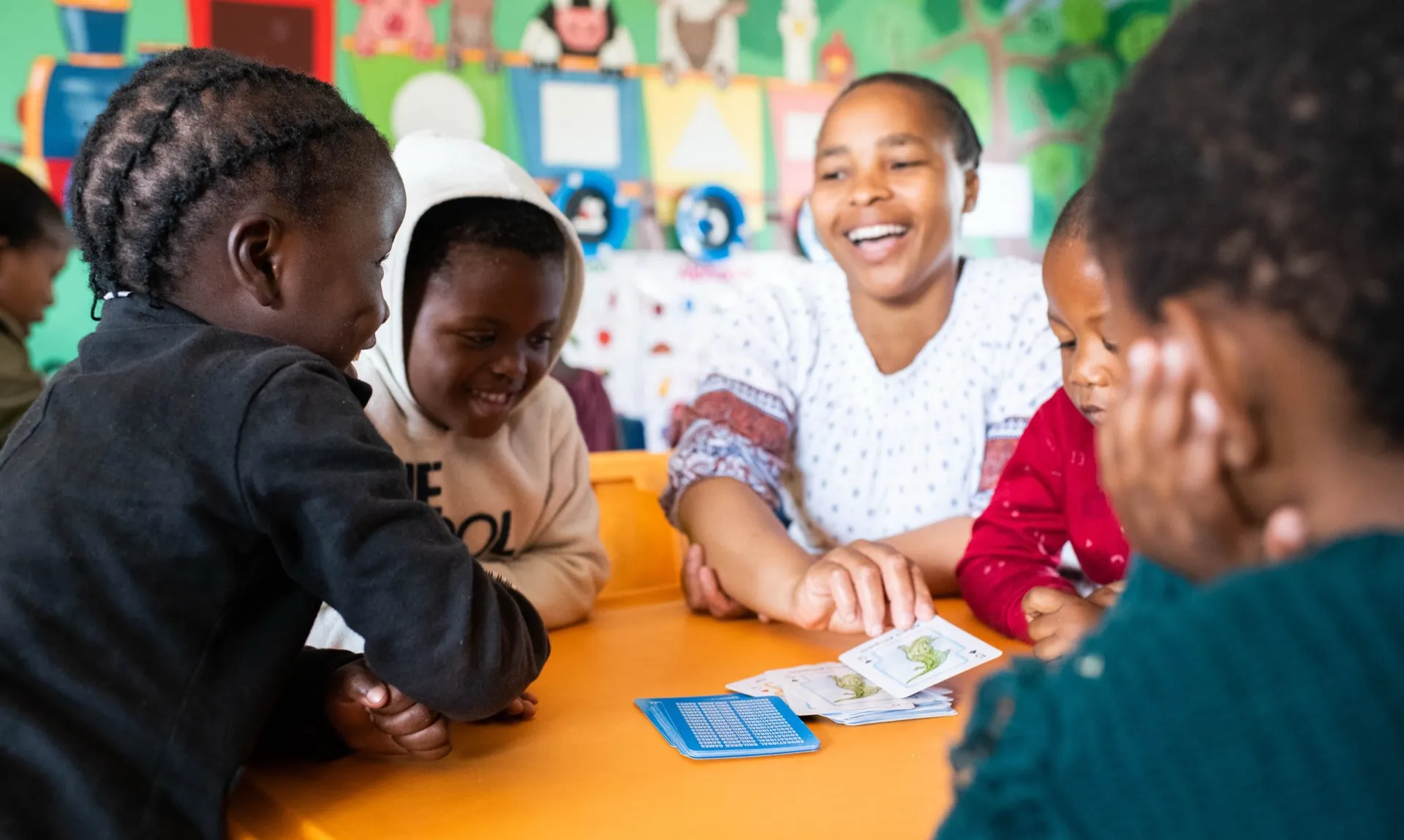 An educator laughing with her students at story time