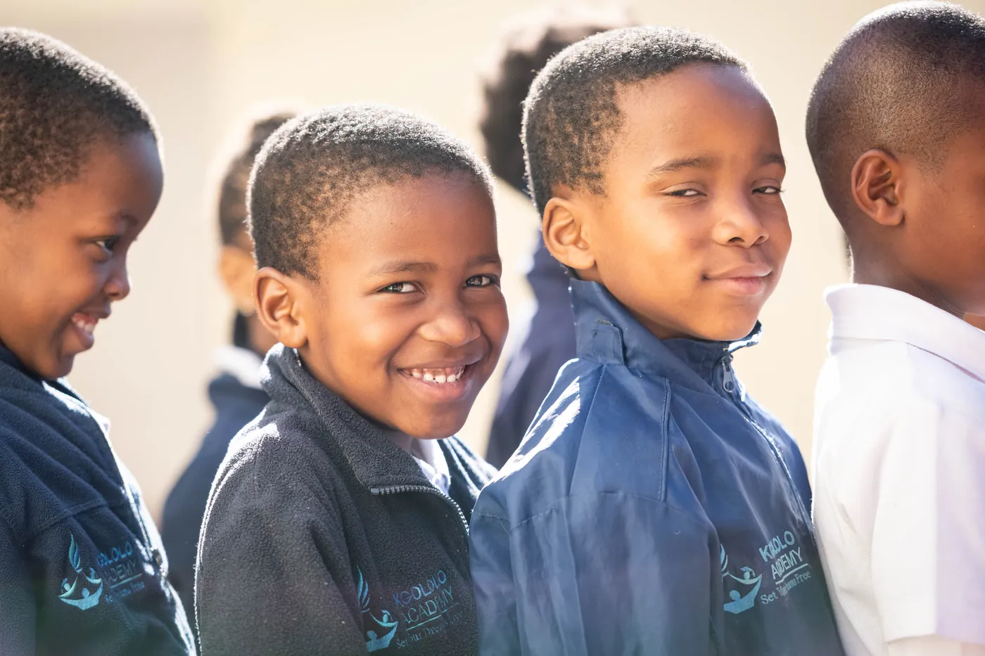 Kgololo Academy schoolboys smiling in the sun