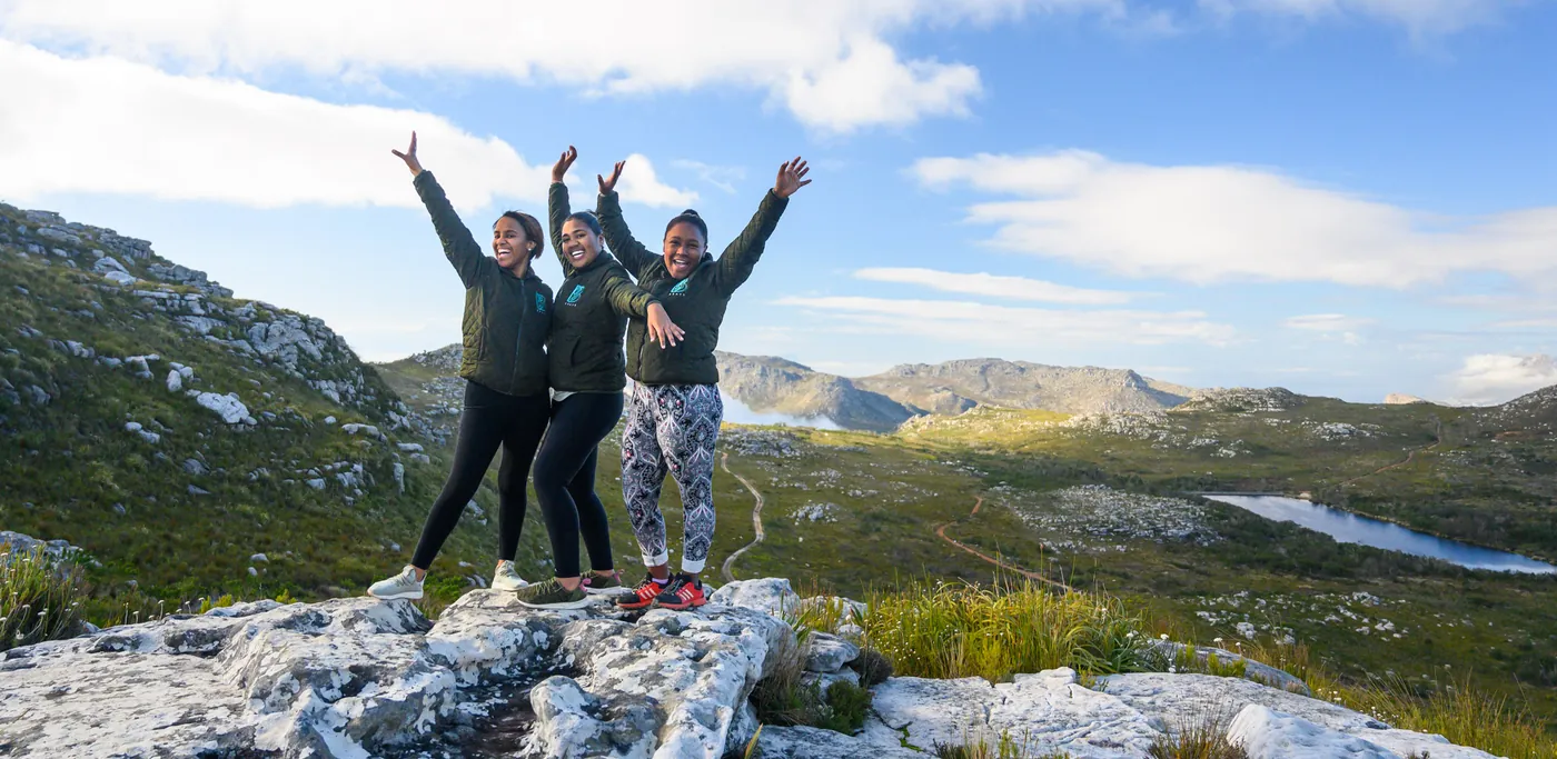 BRAVE young women celebrating on a mountain summit