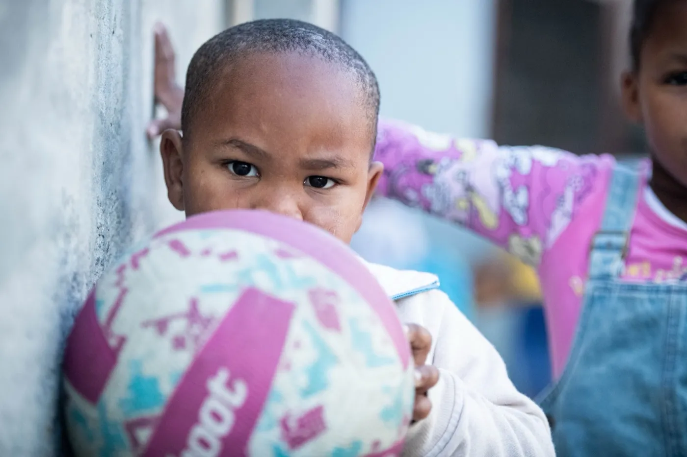 A child holding a ball at a True North early learning centre